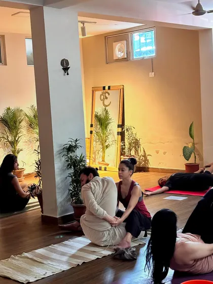 A gentle assist in a seated twist. This helps the student to deepen the rotation in their spine while keeping their hips grounded.