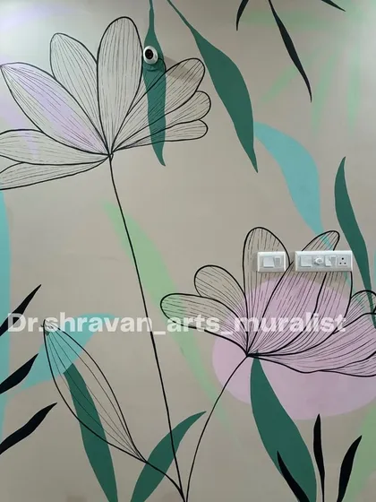 A simple and elegant boho floral mural. The clean black lines defining the flowers against a backdrop of soft pastel shapes create a modern and calming effect.