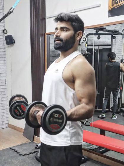 Don't limit your challenges, challenge your limits. Here I am performing dumbbell curls, a classic exercise for building bicep strength and arm definition.