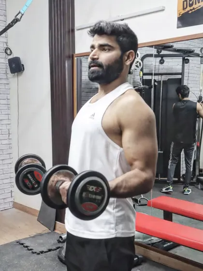 Don't limit your challenges, challenge your limits. Here I am performing dumbbell curls, a fundamental exercise for building arm strength and muscle definition.