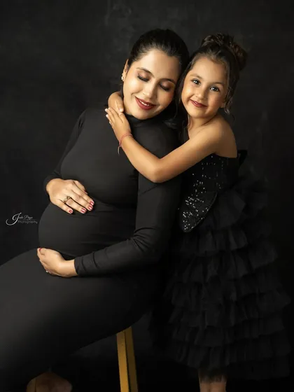Welcoming a new baby is a journey for the whole family. This maternity portrait captures the sweet anticipation and the special bond between a mother and her first child before the new arrival.