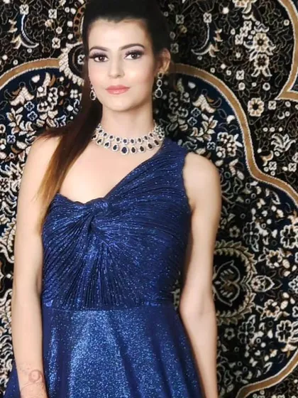 A full shot of the shimmery blue gown. The twisted knot detail on the bodice adds a stylish touch to this elegant party dress.