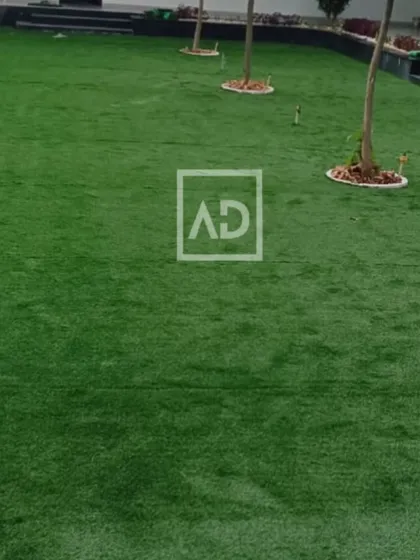 A large poolside area covered with artificial grass. It provides a soft, non-slip surface that stays green all year round without watering or mowing.