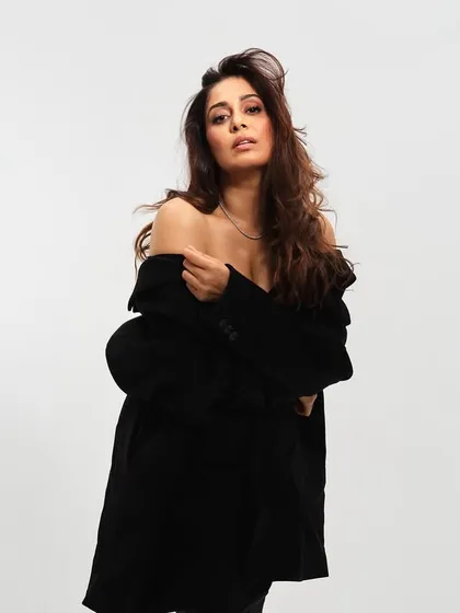 This portrait highlights the texture and volume of the blowout hairstyle. The makeup remains soft and neutral, allowing the model's natural beauty to be the focus.