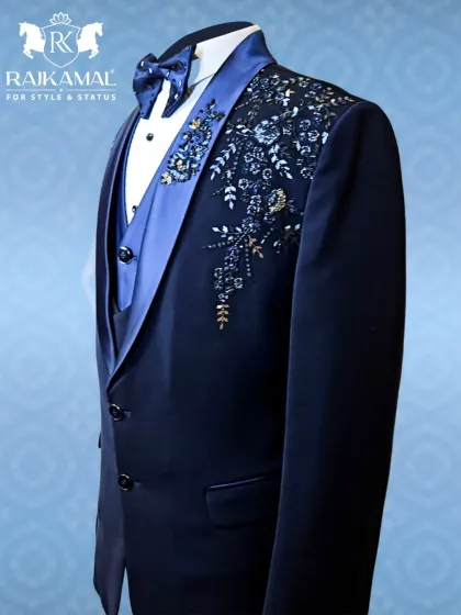 A slightly different angle of the navy blue tuxedo, showing how the light catches the gold and silver threads in the embroidery.