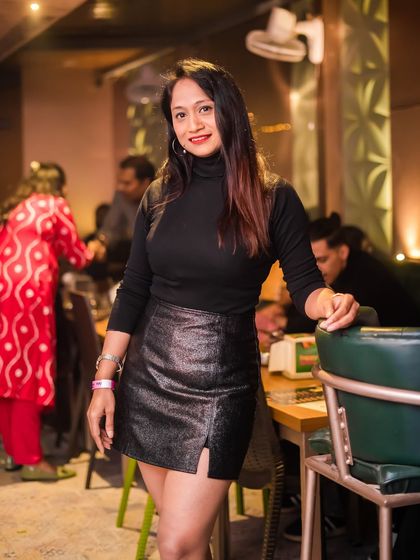 A guest posing by her table, enjoying the club's ambiance.