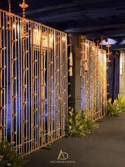 A wider view of the entrance corridor, lined with the beautiful curtains of light and flowers, guiding guests towards the main celebration.