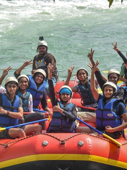 A boat full of happy and excited students, ready for their rafting adventure.
