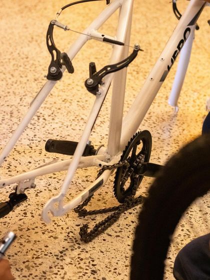 Here you can see the bicycle frame stripped down, with the chain and brake assembly exposed. This is what it looks like when we break things down to their fundamental parts to understand them.