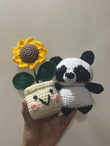 A happy little panda and a smiling sunflower pot. This pair was created as a cheerful desk set to bring a bit of joy to a workspace.