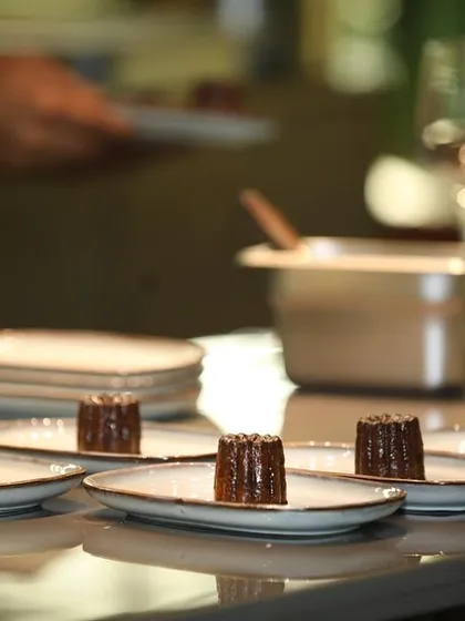 A lineup of Canelés, ready to be served as the final sweet bite of the evening.