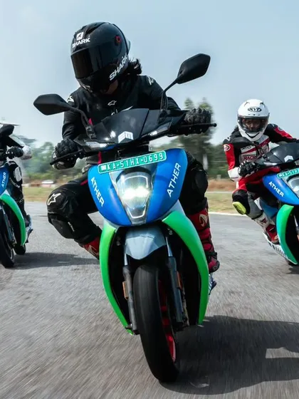 A head-on shot of three riders on Ather electric scooters, showcasing the intense competition during the EV racing festival we hosted.