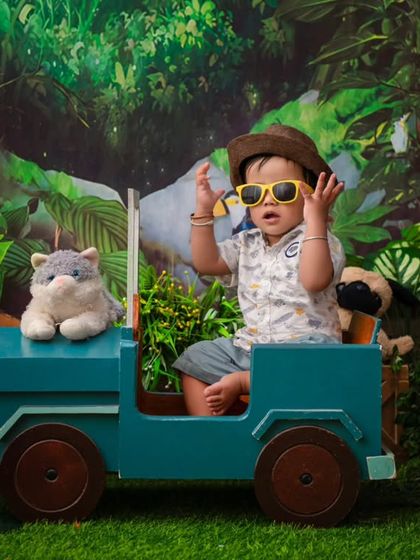A cool dude on a jungle safari. The sunglasses and jeep prop add a fun and adventurous twist to this jungle-themed shoot.