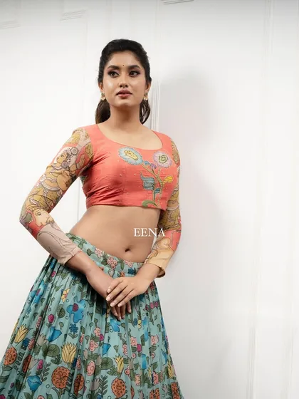 Discover the beauty of traditional craftsmanship with this stunning Pen Kalamkari lehenga. The piece is meticulously hand-painted by my artisans, with a story unfolding on the blouse sleeves and a beautiful floral pattern on the skirt and dupatta.