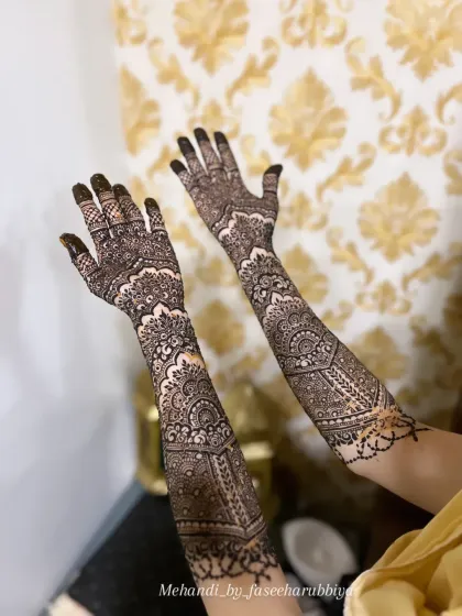 Shaziya's engagement henna, featuring beautiful mandala work and detailed patterns extending up the forearms.