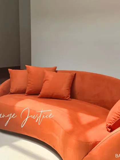 We love a bold pop of color. This custom-designed curved sofa in a vibrant orange makes a powerful statement, proving that your furniture can be both a centerpiece and a work of art.