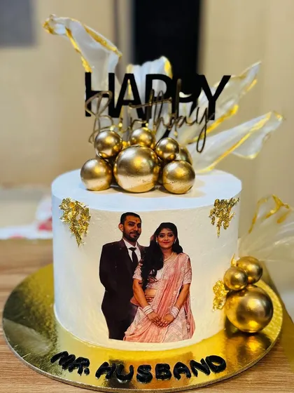 A personalized birthday cake for a husband with a photo of the couple.