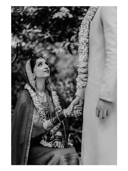 A romantic black and white shot, capturing a tender moment between the couple.
