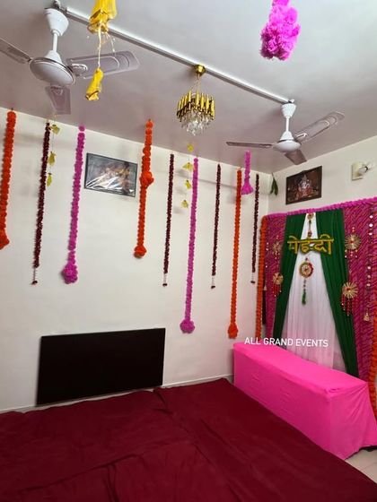 Another view of the at-home Mehendi decoration, showing how the ceiling hangings and the main backdrop work together to create a cohesive and celebratory atmosphere.