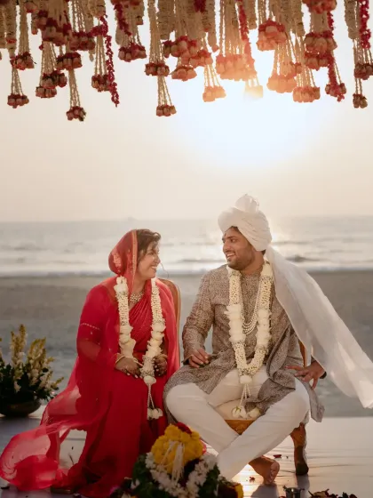 A moment of pure joy between the couple at their sunset wedding in Goa. The golden light, the sound of the waves, and the traditional floral decor created a truly magical 'ehsaas' (feeling).