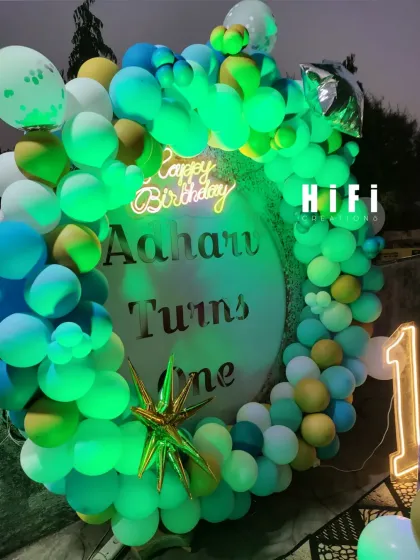 The outdoor birthday setup under green lighting.