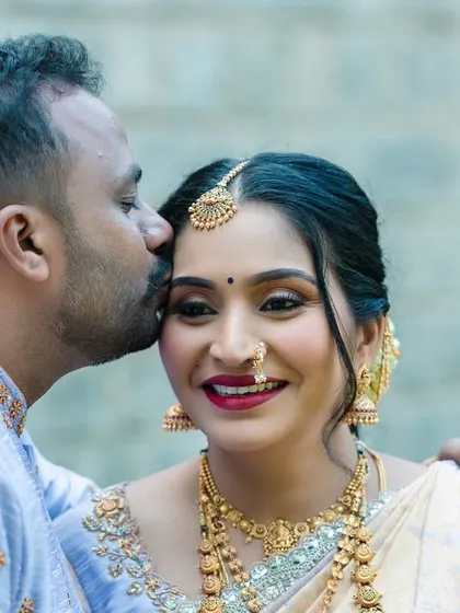 A close-up portrait filled with affection. This shot focuses on the tender connection between the couple during their traditional maternity photoshoot.