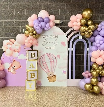 A sweet "We Can Bearly Wait" theme in pastel pink and purple with gold accents, featuring baby blocks and a hot air balloon graphic.