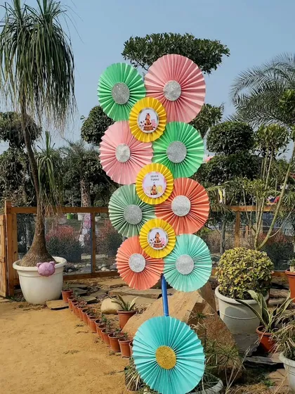 A close-up of the vibrant paper pinwheel tower used as entrance decor. The mix of pastel colors and themed stickers tied in perfectly with the farm aesthetic.