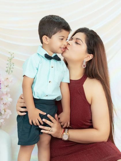 A sweet kiss for her little boy. We focus on capturing these small, loving gestures that define the mother-child relationship.