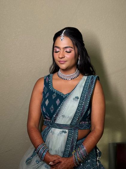 An eyes-closed shot to highlight the rosy-hued eyeshadow and the radiant glow of her skin.