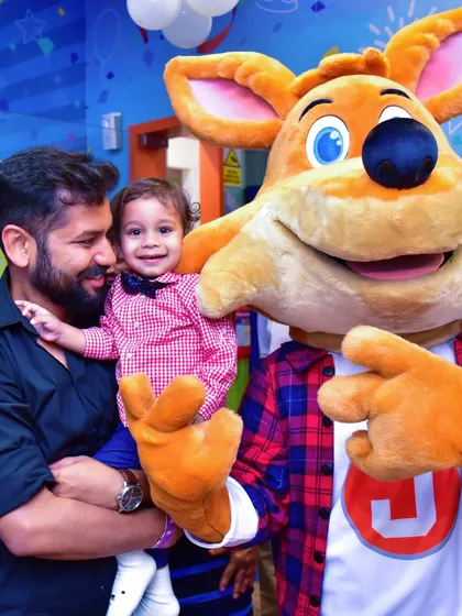 A father and his toddler share a happy moment with J the Fox. Our mascot is always ready for a hug and a photo.