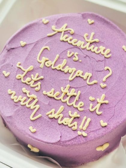 A fun purple bento cake with a debate to be settled with shots. We love creating cakes that capture the unique humor of your friend group.