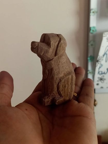 The finished hand-whittled dog, small enough to sit in the palm of my hand. This piece showcases the texture and character that can be achieved with simple hand tools.