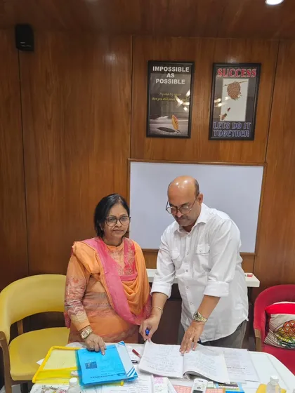 Assisting a participant with her numerology calculations during the workshop. I ensure everyone gets personal attention.