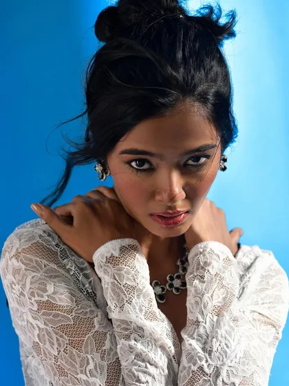 A powerful, direct portrait that showcases the jewellery in a high-fashion context. The intense gaze adds a layer of drama to the commercial shot.