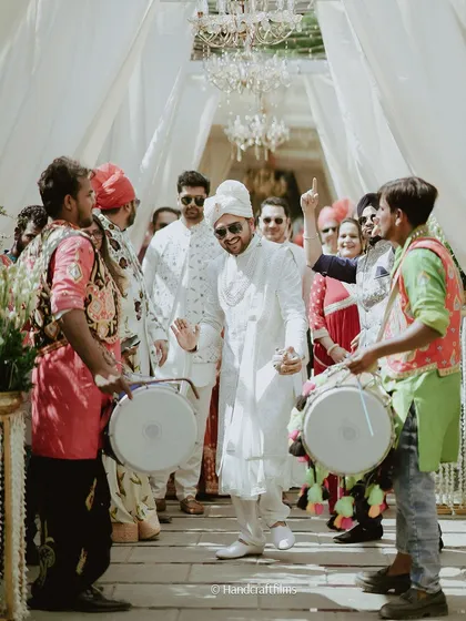 The groom's grand entrance with dhol players. The energy and excitement of a baraat are an essential part of a North Indian wedding.