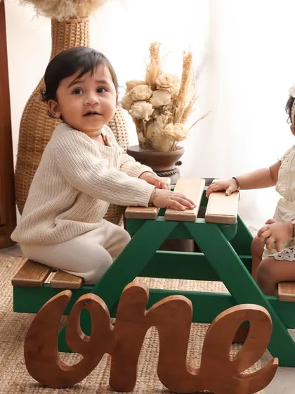 Double the fun! This first birthday shoot for twins, featuring a miniature picnic bench, is all about celebrating their special milestone together. Capturing the unique bond of twins is always a magical experience.