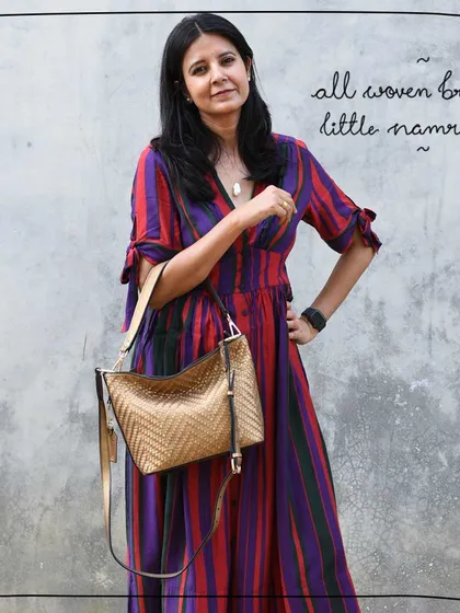 Tulika carries the All Woven Bronze Little Namrata as a crossbody bag, showing its versatility.