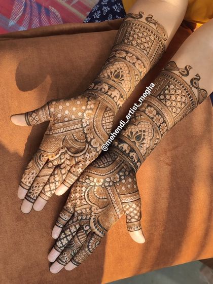 A gorgeous, flowing design that extends up the arms. The patterns are continuous and connected, featuring peacocks and geometric bands that create a sense of rhythm and elegance.