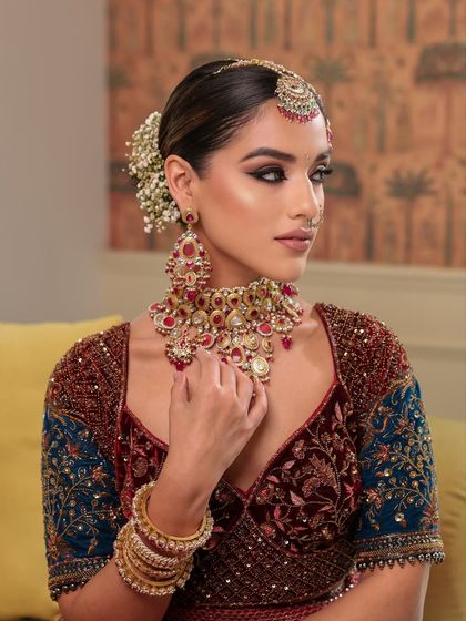 A portrait that captures the grace of a traditional bride. The look features rich embroidery, intricate jewels, and flawless glam.