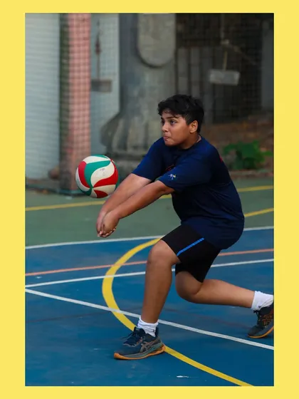 A young player gets low to execute a controlled bump pass. We teach the importance of proper body mechanics in every drill.