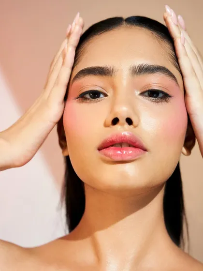 A confident pose that shows off the beautiful, glowing skin. The makeup is minimal yet impactful, proving that less can be more.