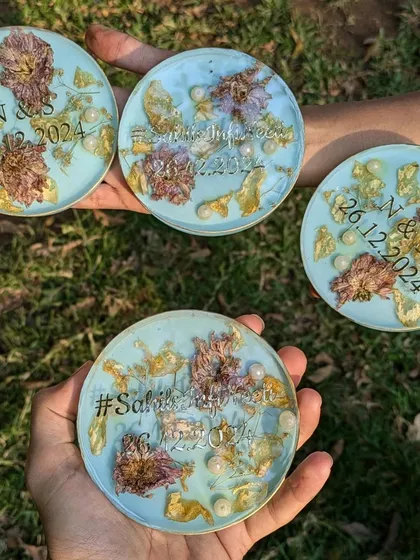 A full set of the custom pastel blue coasters, each personalized with initials, dates, and hashtags. They make for a beautiful and cohesive gift set.