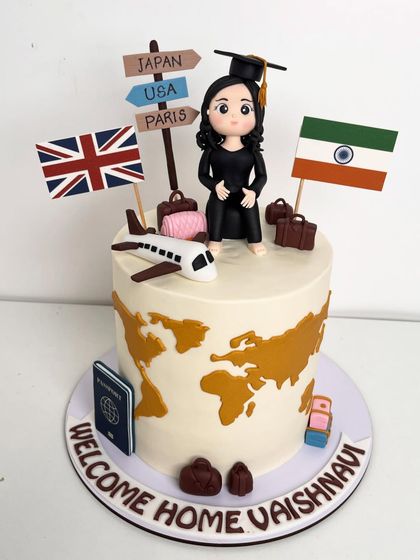 Another angle of the travel-themed graduation cake, showing the details of the destination signs and the flags.