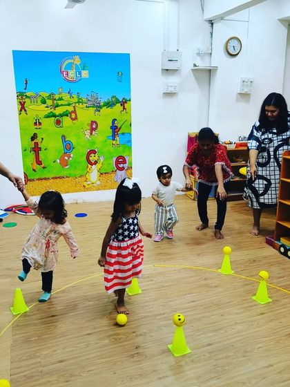 This is a typical scene from one of my indoor sessions. We use colorful cones and soft balls to create exciting obstacle courses and games. It’s organized chaos that helps children improve their agility, coordination, and ability to follow instructions.