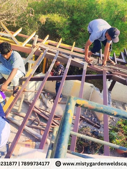 A team of my workers applying a finishing coat to a pergola frame. This crucial step protects the metal from the elements and ensures a durable, long-lasting finish.