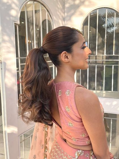 Another side view of the wavy ponytail, showing how it gracefully falls over the shoulder.