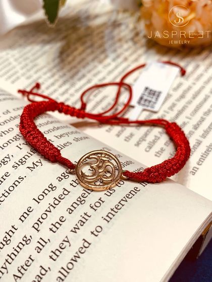 The sacred Om symbol, crafted in 14kt gold and set on a traditional red thread. This bracelet is a simple yet powerful piece of spiritual jewelry, perfect for daily wear or as a thoughtful gift.