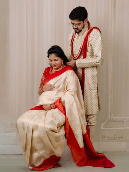 An intimate and tender moment between a couple in beautiful traditional clothing. The husband's gesture is full of care and affection.