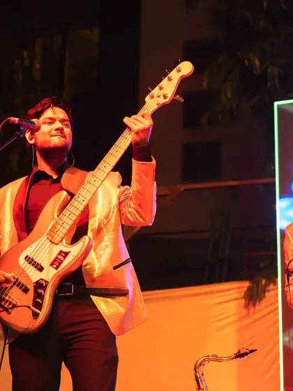 Our bassist and saxophonist in action during a Christmas performance. The warm stage lighting and festive decor created a great atmosphere for the holiday event.